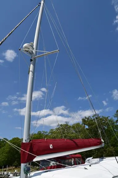 Slide: The Image of Sailboat mast and red sail on 2014 Fountaine Pajot Mahe 36 Evolution under blue sky. - 6
