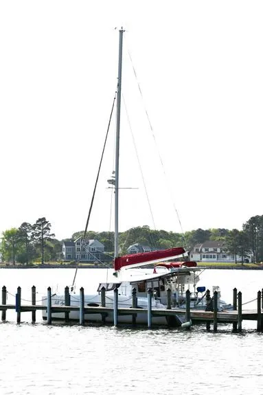 Slide: The Image of 2014 Fountaine Pajot Mahe 36 Evolution catamaran docked by waterfront homes. - 7