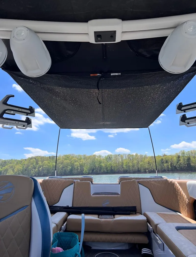 Slide: The Image of 2022 Tigé 24RZX boat interior with speakers, lake view, and blue sky. - 11