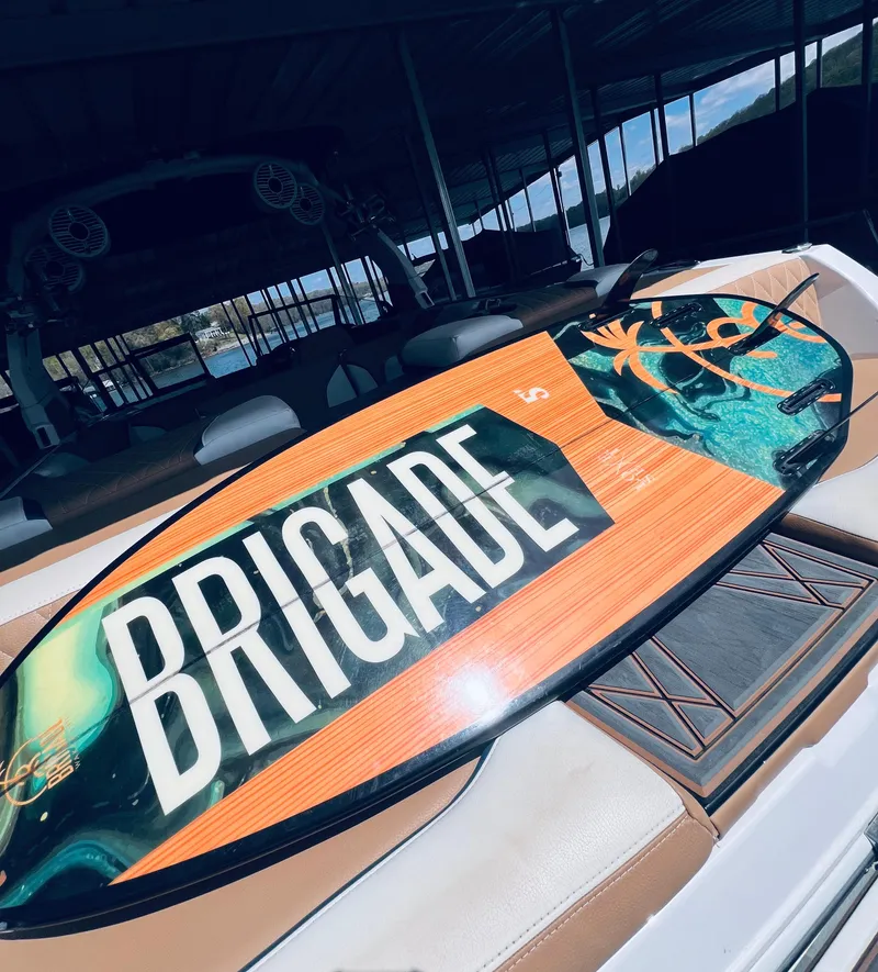 Slide: The Image of 2022 Tigé 24RZX boat with a Brigade wakeboard on deck. - 14