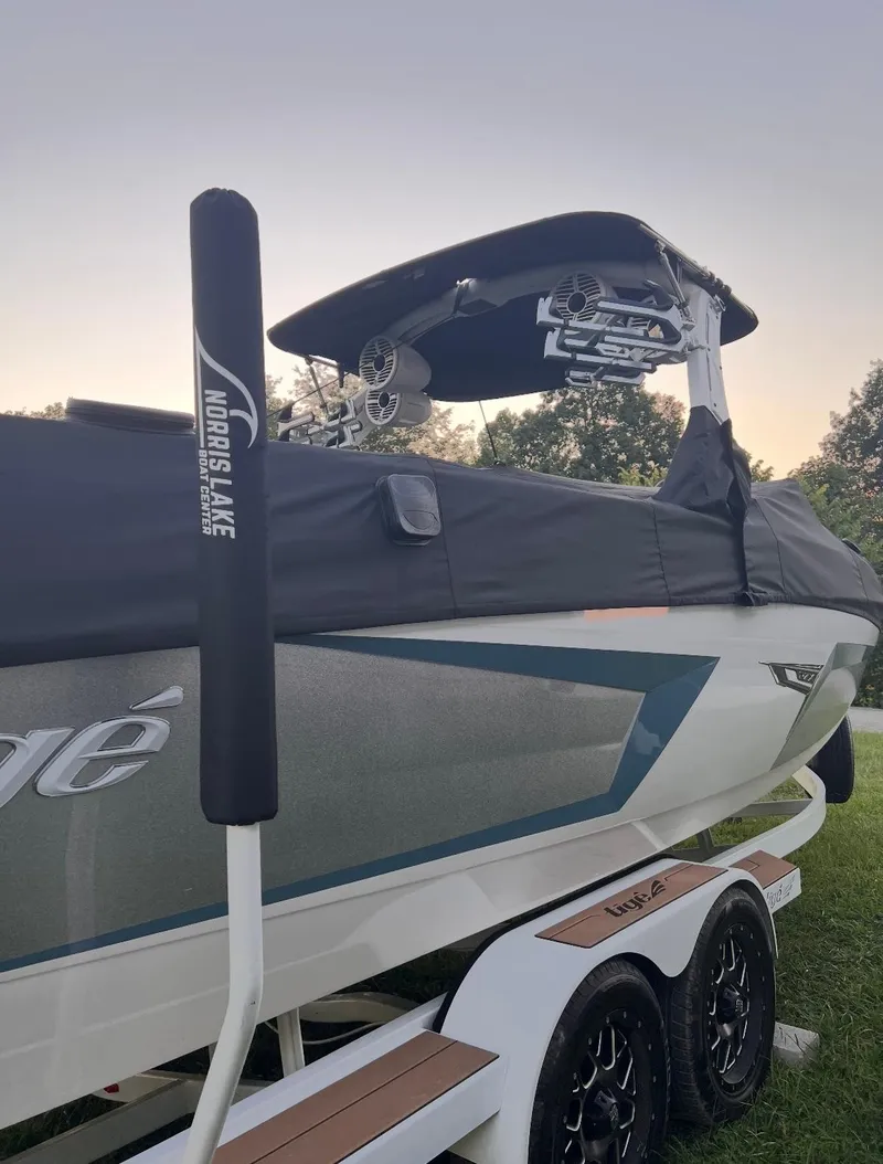 Slide: The Image of 2022 Tigé 24RZX boat on trailer with cover, featuring sleek design and modern features. - 8