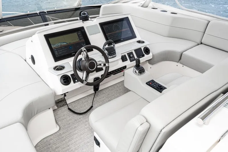Slide: The Image of 2019 Tiara Yachts F 53 helm with modern navigation displays and luxurious seating. - 17