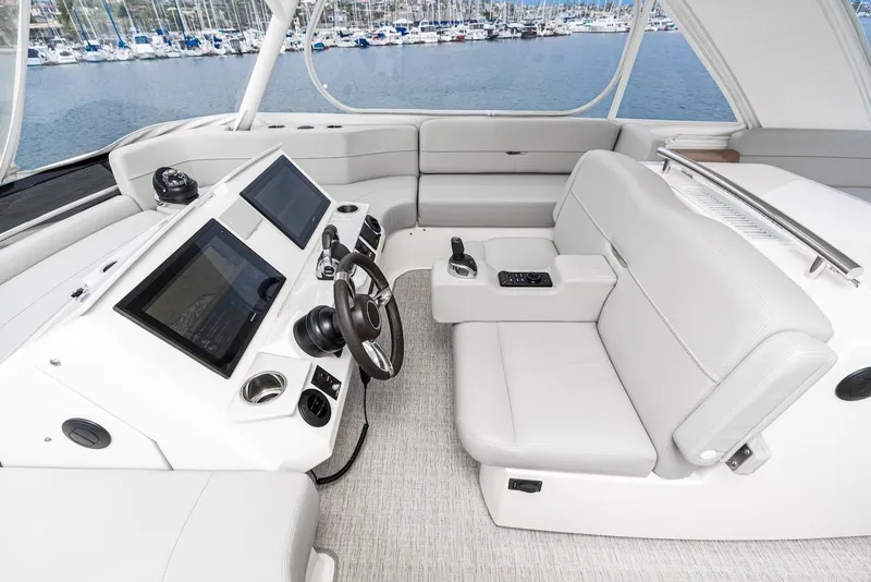 Slide: The Image of 2019 Tiara Yachts F 53 helm with modern controls and luxurious seating. - 19