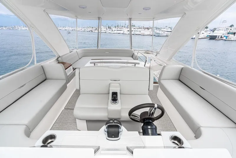 Slide: The Image of Luxurious 2019 Tiara Yachts F 53 interior with spacious seating and helm, overlooking marina. - 23