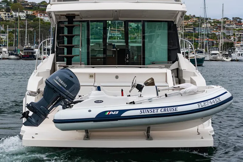 Slide: The Image of 2019 Tiara Yachts F 53 with Yamaha motor and inflatable boat, docked in marina. - 26