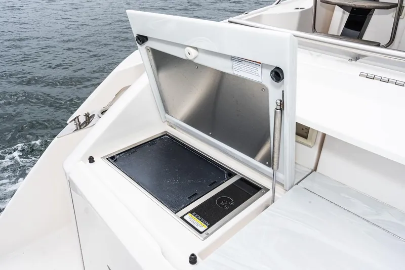 Slide: The Image of Outdoor grill on 2019 Tiara Yachts F 53, open lid, near water. - 28