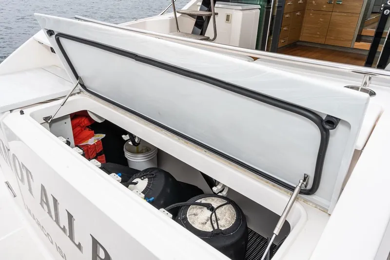 Slide: The Image of 2019 Tiara Yachts F 53 storage compartment with safety equipment and supplies. - 29