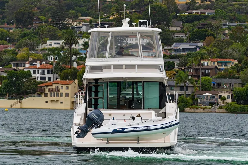 Slide: The Image of 2019 Tiara Yachts F 53 cruising near scenic waterfront homes. - 3
