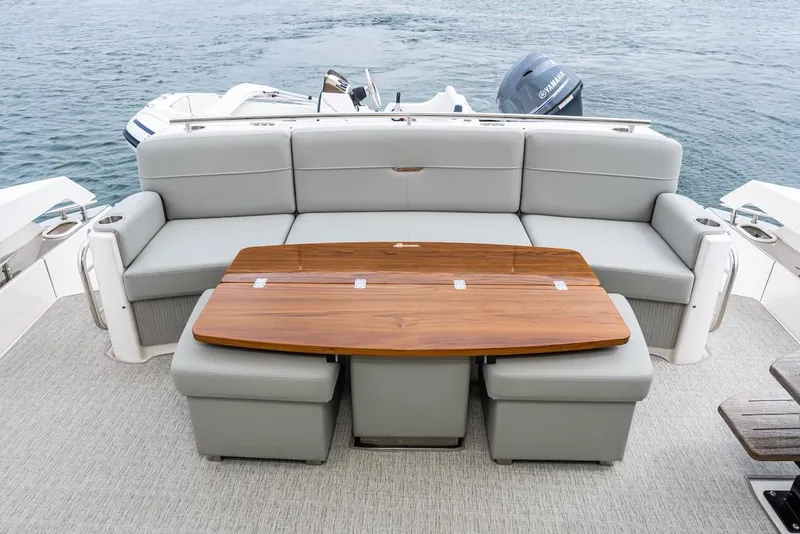 Slide: The Image of 2019 Tiara Yachts F 53 boat interior with gray seating and wooden table. - 31