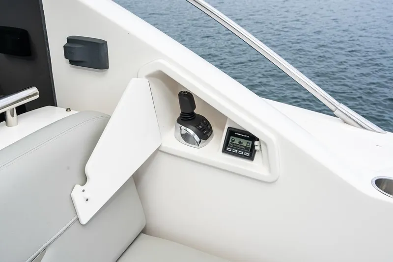 Slide: The Image of Control panel of 2019 Tiara Yachts F 53, featuring joystick and display, overlooking water. - 34