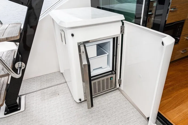 Slide: The Image of Open mini fridge on 2019 Tiara Yachts F 53, showcasing interior storage. - 35