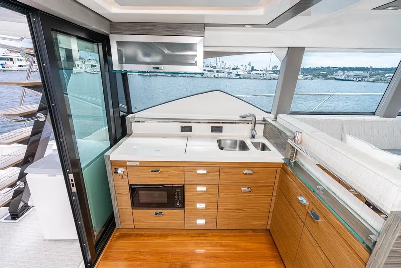 Slide: The Image of Modern kitchen interior on 2019 Tiara Yachts F 53, featuring sleek cabinetry and ocean view. - 40