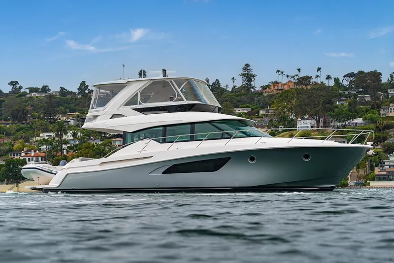 Slide: The Image of 2019 Tiara Yachts F 53 luxury yacht on calm water, scenic background. - 6