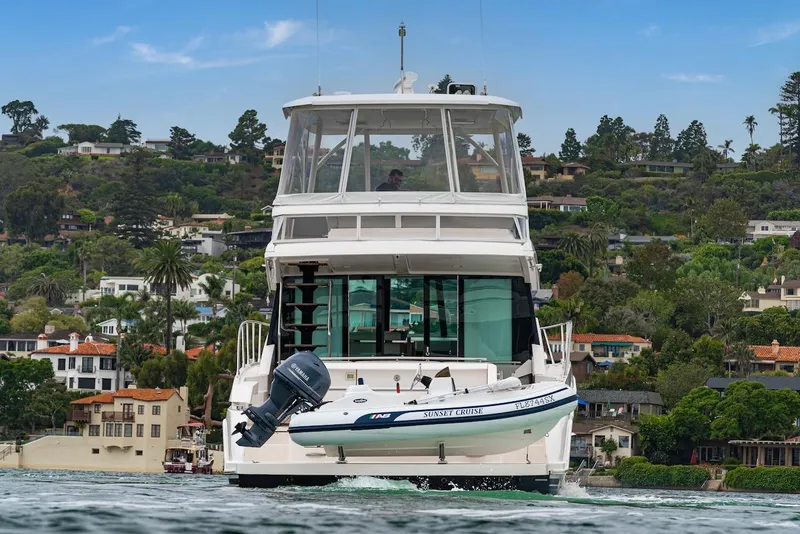 Slide: The Image of 2019 Tiara Yachts F 53 cruising near scenic coastal homes. - 8