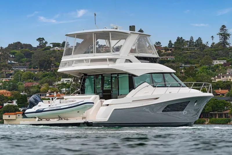 Slide: The Image of 2019 Tiara Yachts F 53 cruising on water with scenic background. - 9