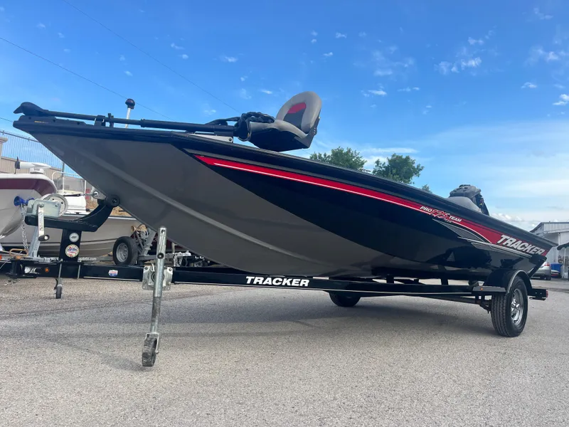 Slide: The Image of 2016 Tracker Pro Team 175 boat on trailer, parked outdoors under blue sky. - 10