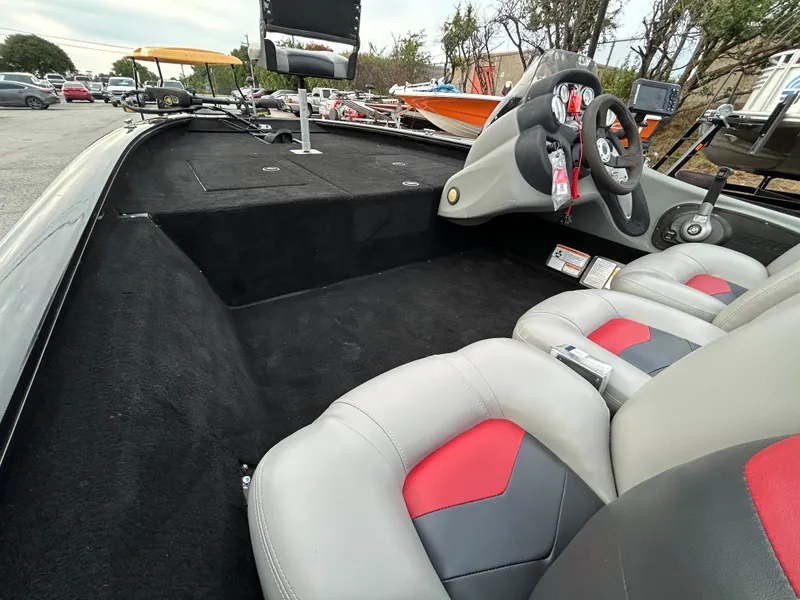 Slide: The Image of 2016 Tracker Pro Team 175 TXW boat interior with steering console and seating. - 14
