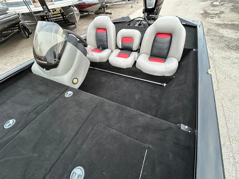 Slide: The Image of 2016 Tracker Pro Team 175 TXW boat interior with three seats and steering console. - 15