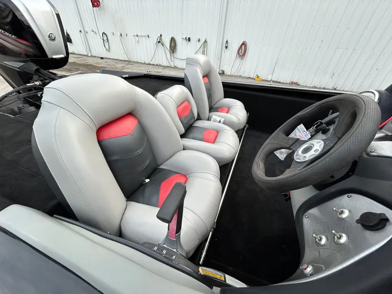 Slide: The Image of 2016 Tracker Pro Team 175 TXW boat interior with gray and red seats, steering wheel visible. - 17