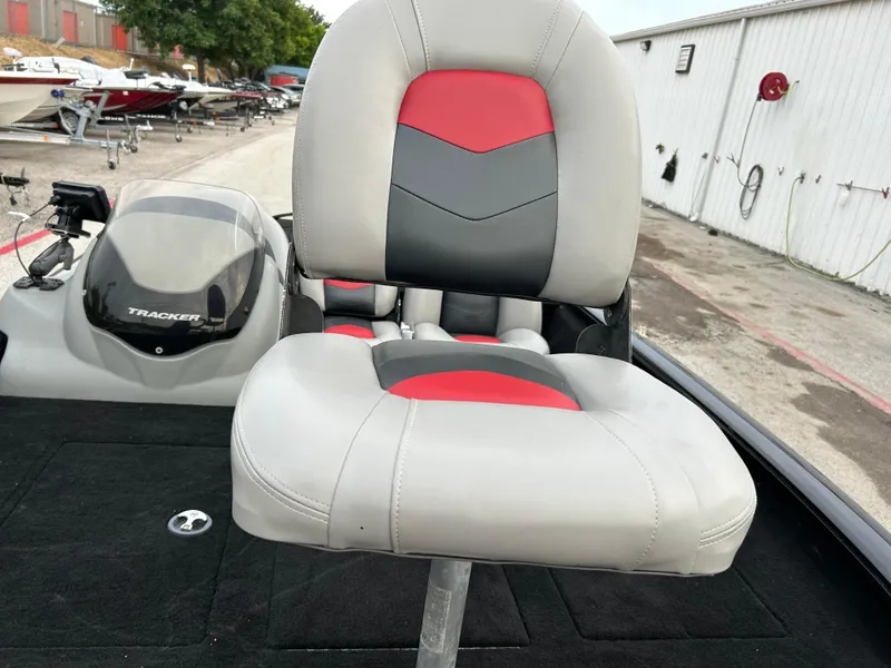 Slide: The Image of 2016 Tracker Pro Team 175 TXW boat seat with red and gray upholstery. - 20