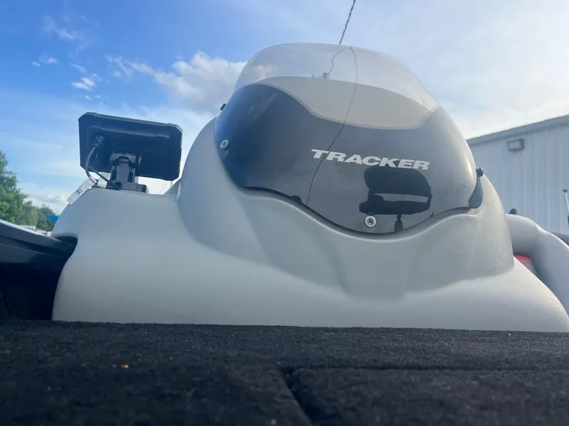 Slide: The Image of 2016 Tracker Pro Team 175 boat console with windshield and logo, under a clear sky. - 25