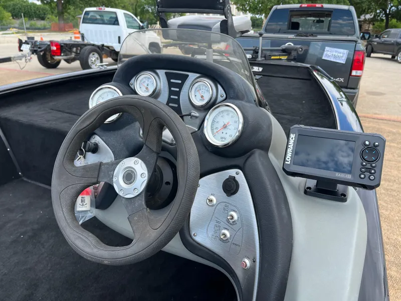 Slide: The Image of 2016 Tracker Pro Team 175 TXW boat dashboard with steering wheel and navigation system. - 32