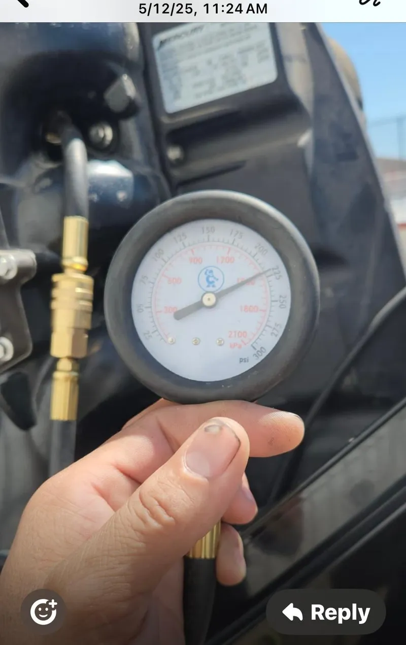 Slide: The Image of Hand holding a pressure gauge on a 2016 Tracker Pro Team 175 TXW boat. - 36