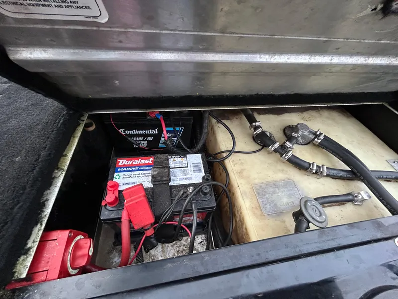 Slide: The Image of 2016 Tracker Pro Team 175 TXW boat battery compartment with Duralast and Continental batteries. - 44