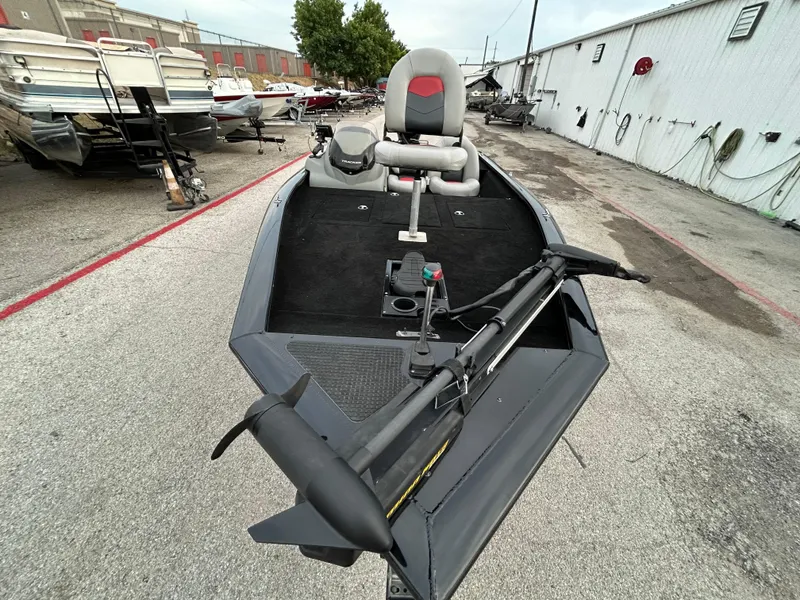 Slide: The Image of 2016 Tracker Pro Team 175 TXW boat, parked outdoors, featuring a trolling motor and seating. - 50