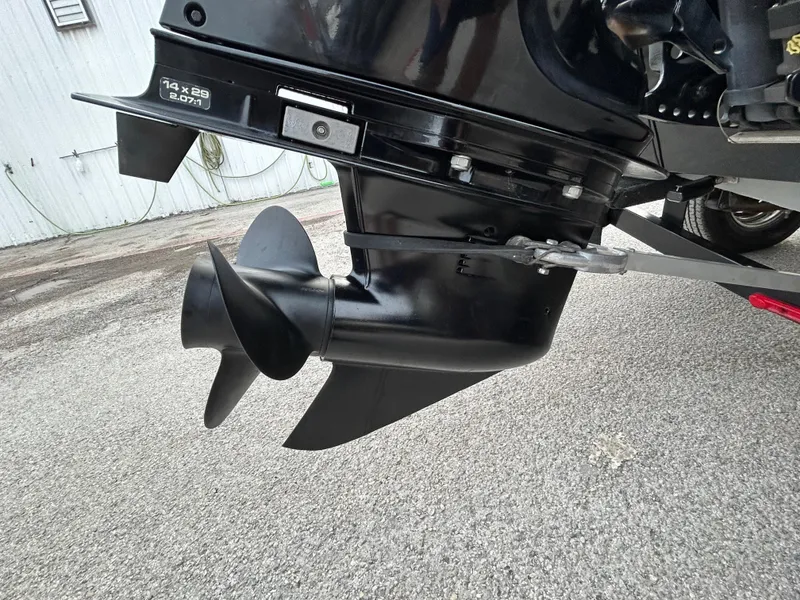 Slide: The Image of 2016 Tracker Pro Team 175 TXW boat propeller on asphalt surface. - 54