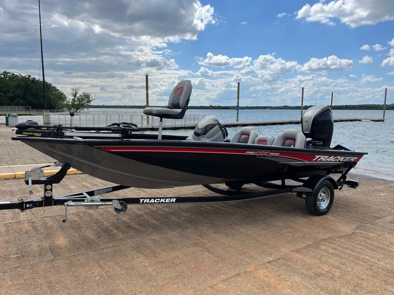 Slide: The Image of 2016 Tracker Pro Team 175 TXW boat on trailer by a lake under cloudy sky. - 9