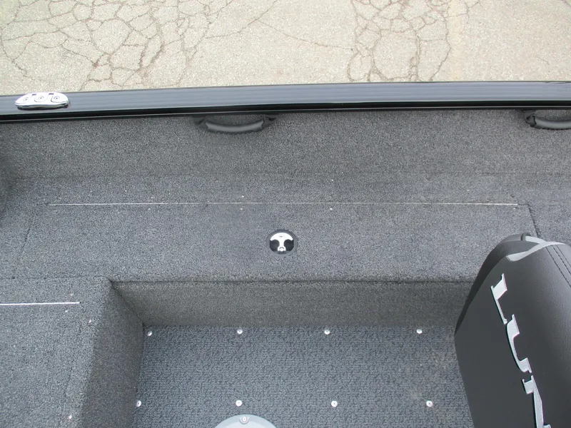 Slide: The Image of 2025 Lund Rebel XL 1650 SS boat interior with gray carpet and seating. - 13