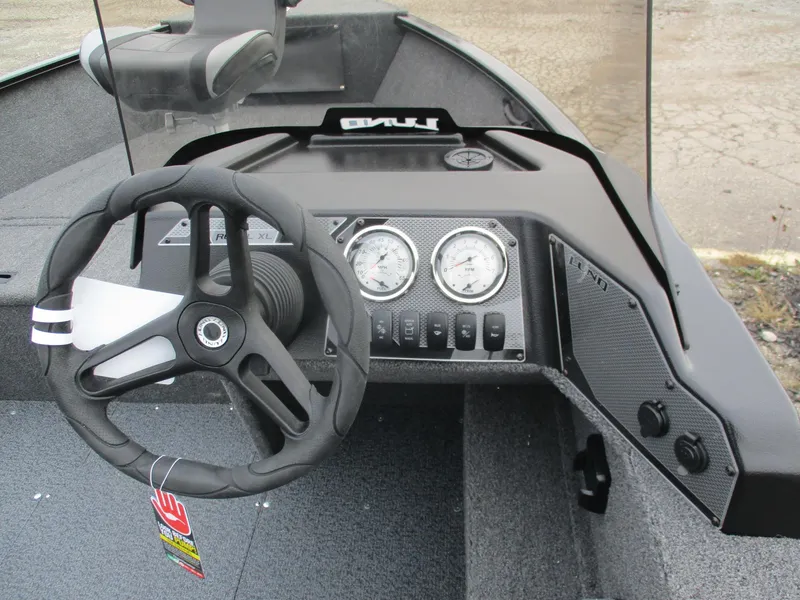 Slide: The Image of 2025 Lund Rebel XL 1650 SS boat dashboard with steering wheel and gauges. - 3