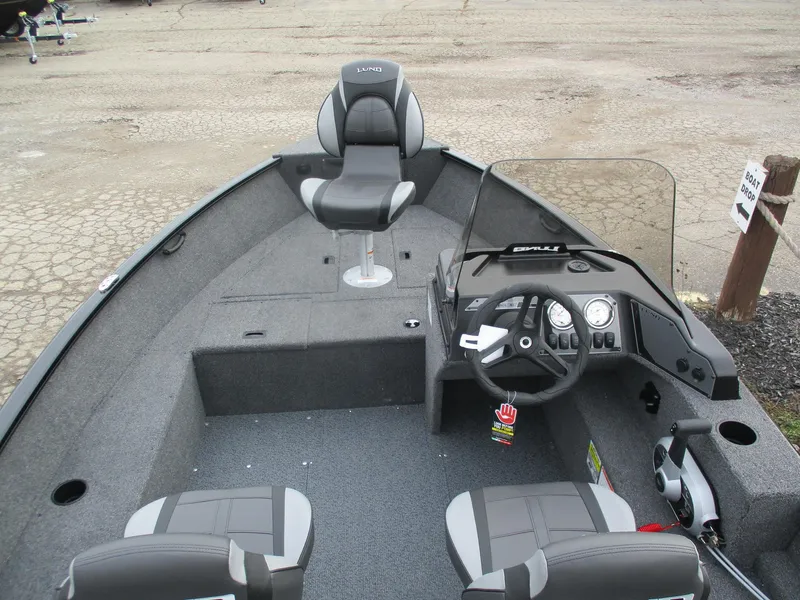 Slide: The Image of 2025 Lund Rebel XL 1650 SS boat interior with steering console and seating. - 8