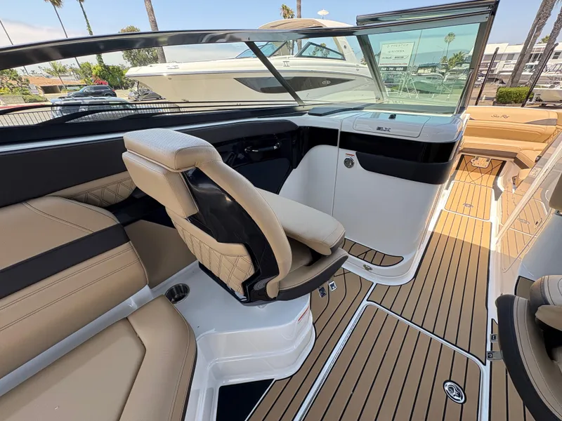 Slide: The Image of 2026 Sea Ray SLX 280 boat interior with tan seating and sleek design. - 7