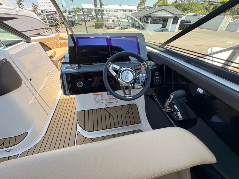 Slide: The Image of 2026 Sea Ray SLX 280 boat cockpit with modern steering wheel and dual screens. - 8