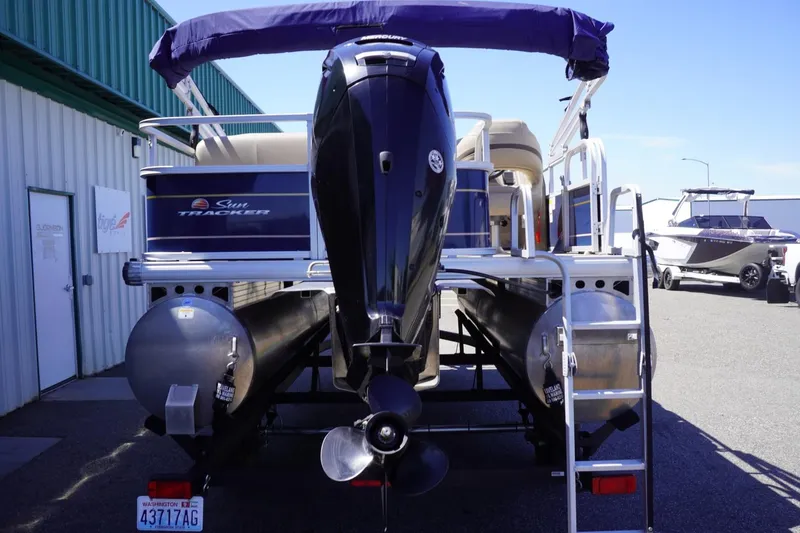 Slide: The Image of 2022 Sun Tracker Party Barge 18 DLX pontoon boat, rear view with motor and ladder. - 10