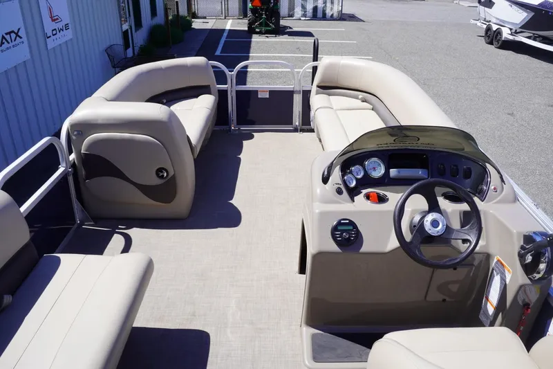 Slide: The Image of 2022 Sun Tracker Party Barge 18 DLX pontoon boat interior with seating and steering console. - 13