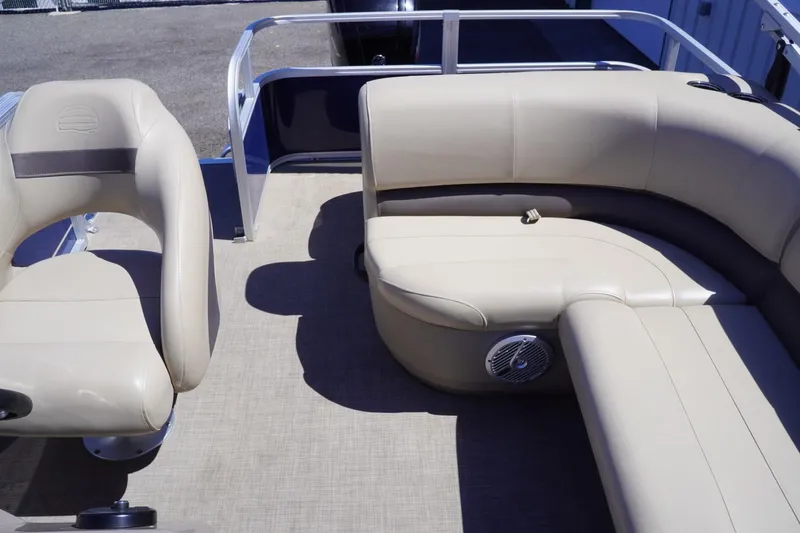 Slide: The Image of 2022 Sun Tracker Party Barge 18 DLX interior with beige seating and speaker. - 16