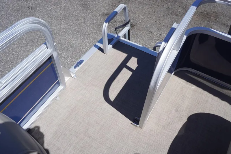 Slide: The Image of 2022 Sun Tracker Party Barge 18 DLX deck with aluminum railings and textured flooring. - 19