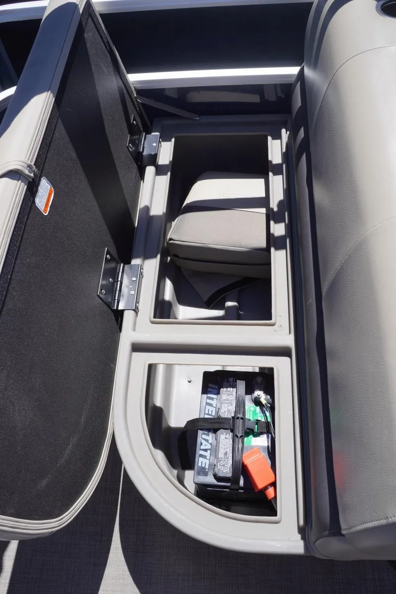 Slide: The Image of 2022 Sun Tracker Party Barge 18 DLX storage compartment with battery and accessories. - 22