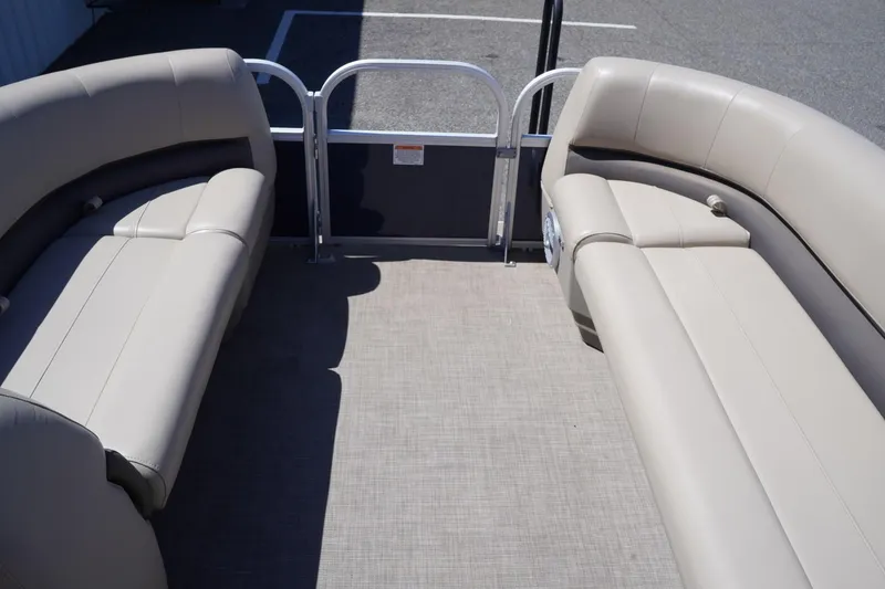 Slide: The Image of 2022 Sun Tracker Party Barge 18 DLX interior with beige seating and open deck space. - 24