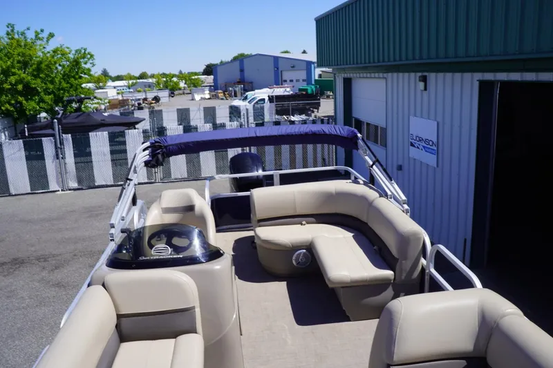 Slide: The Image of 2022 Sun Tracker Party Barge 18 DLX pontoon boat with spacious seating, docked outdoors. - 29