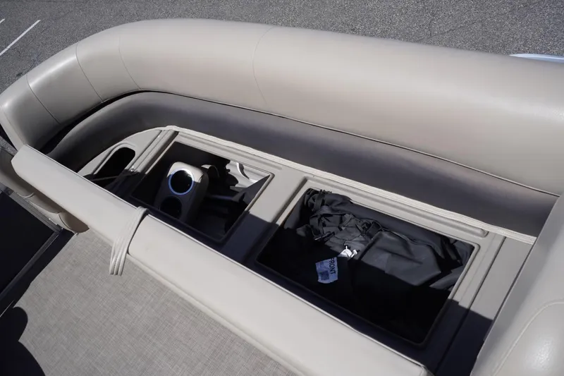 Slide: The Image of 2022 Sun Tracker Party Barge 18 DLX interior storage compartment with cup holder. - 31