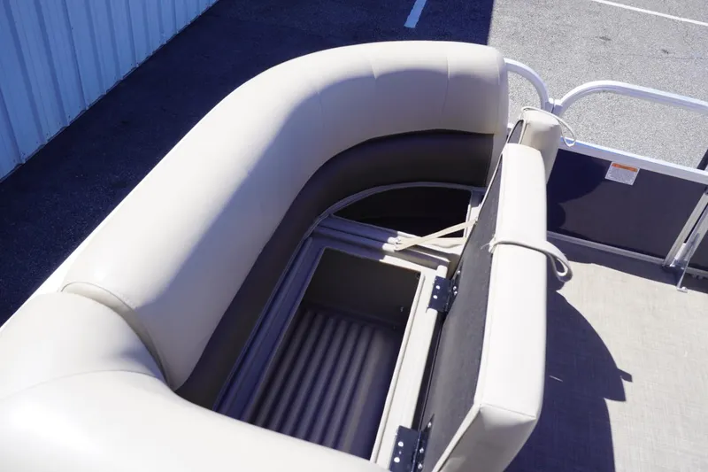 Slide: The Image of 2022 Sun Tracker Party Barge 18 DLX with open storage compartment and cushioned seating. - 32