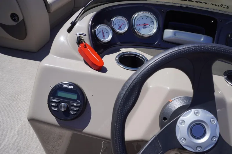 Slide: The Image of 2022 Sun Tracker Party Barge 18 DLX dashboard with steering wheel and gauges. - 34