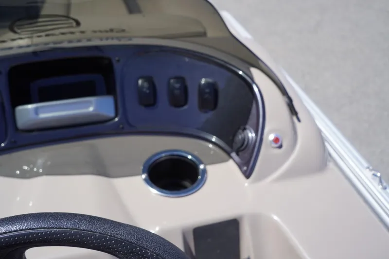 Slide: The Image of 2022 Sun Tracker Party Barge 18 DLX dashboard with controls and cup holder. - 36