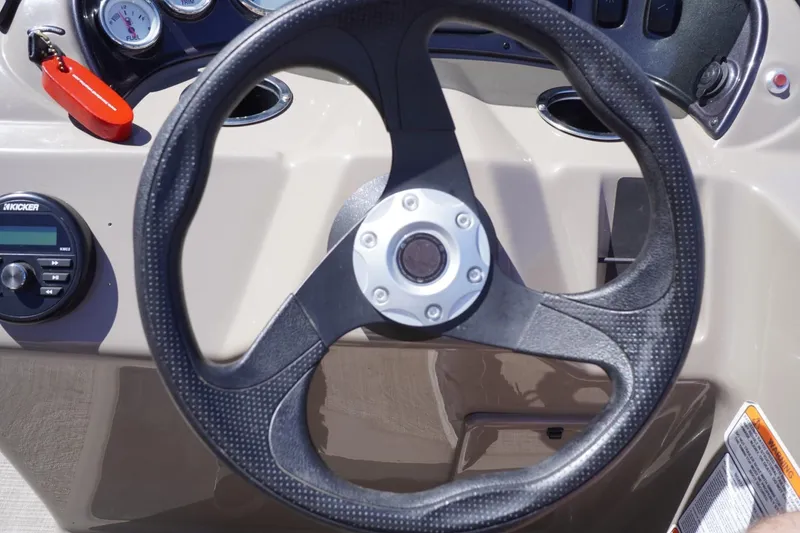 Slide: The Image of Steering wheel of 2022 Sun Tracker Party Barge 18 DLX with dashboard controls. - 37