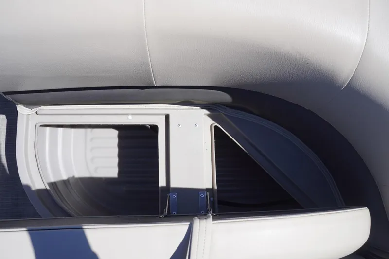 Slide: The Image of 2022 Sun Tracker Party Barge 18 DLX interior detail with seating and storage compartment. - 40