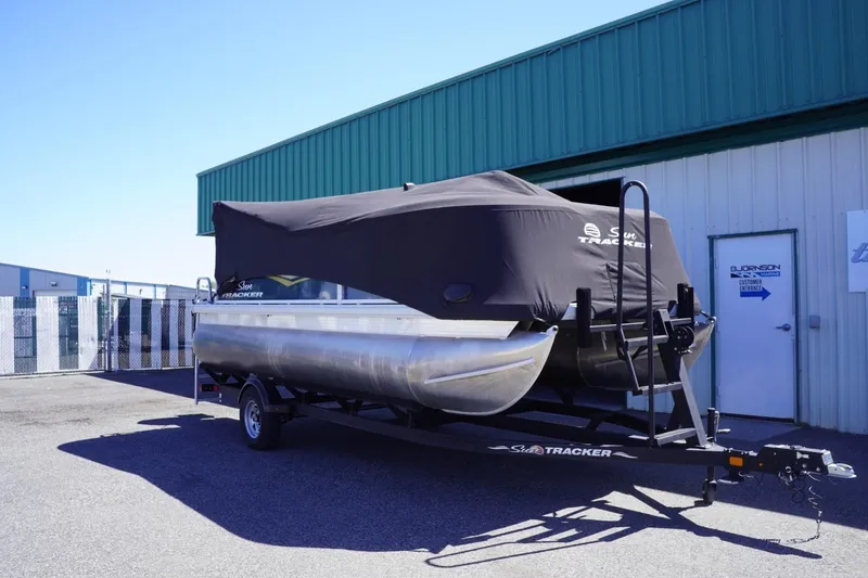 Slide: The Image of 2022 Sun Tracker Party Barge 18 DLX pontoon boat covered and parked on a trailer. - 44